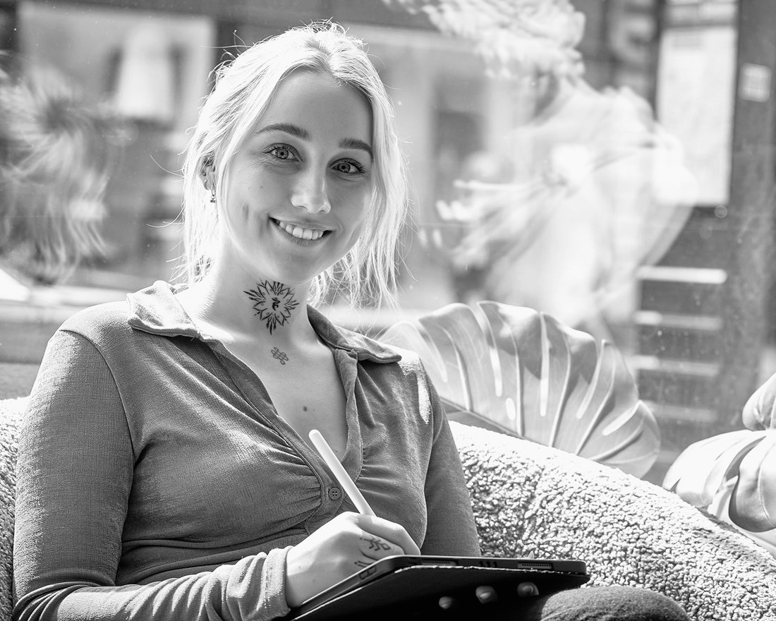 Caroline Lindskov, tattoo artist at Prana Tattoo, sketching on her iPad